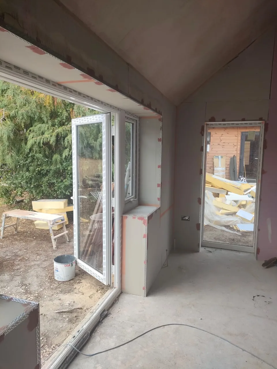 Boarded vaulted room with beads fitted around the windows and doors ready for plastering